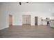 Spacious living room with wood-look floors and white walls, offering ample space and bright, neutral tones at 10712 Aire Dr, Las Vegas, NV 89144