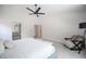 Spacious primary bedroom with a ceiling fan, sitting chair, and an en-suite bathroom at 10712 Aire Dr, Las Vegas, NV 89144