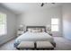 Bright primary bedroom with a neutral palette and features a large window and a cozy seating area at 10712 Aire Dr, Las Vegas, NV 89144