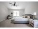 Calming primary bedroom featuring a ceiling fan, sitting chair, and natural light at 10712 Aire Dr, Las Vegas, NV 89144