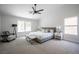 Relaxing primary bedroom featuring a ceiling fan, sitting area, and plenty of natural light at 10712 Aire Dr, Las Vegas, NV 89144
