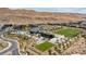 Aerial view of modern community with clubhouse, pool, green spaces, and desert landscaping at 10927 White Clay Dr, Las Vegas, NV 89135