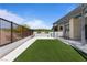 Manicured backyard featuring desert landscaping, privacy fencing, and a covered patio with modern pergola at 10927 White Clay Dr, Las Vegas, NV 89135