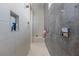 Contemporary shower room featuring built-in shelving and sleek gray tiling at 10927 White Clay Dr, Las Vegas, NV 89135