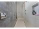 Modern bathroom features sleek tile, a spacious walk-in shower and convenient built-in shelving at 10927 White Clay Dr, Las Vegas, NV 89135