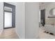 Hallway view leading to a bathroom with a freestanding tub and walk-in shower at 10927 White Clay Dr, Las Vegas, NV 89135