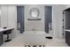 Modern bathroom with a freestanding tub, walk-in shower, and dual vanities at 10927 White Clay Dr, Las Vegas, NV 89135