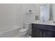 Modern bathroom featuring a tub-shower combo and dark vanity with a white countertop at 10927 White Clay Dr, Las Vegas, NV 89135