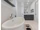 Modern bathroom with a freestanding tub, vanity, and a view into another bathroom at 10927 White Clay Dr, Las Vegas, NV 89135