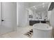 Bright bathroom featuring a soaking tub, vanity, and a view into another bathroom at 10927 White Clay Dr, Las Vegas, NV 89135
