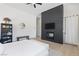 Inviting bedroom featuring contemporary decor, a sleek fireplace, and an array of modern conveniences at 10927 White Clay Dr, Las Vegas, NV 89135