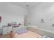 Bright bedroom featuring a bed and a vanity with white drawers at 10927 White Clay Dr, Las Vegas, NV 89135