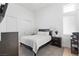 Cozy bedroom with a comfortable queen bed, soft lighting, and minimalist decor at 10927 White Clay Dr, Las Vegas, NV 89135