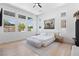 Bright bedroom with white walls, wood floors, ample windows, and stylish contemporary decor at 10927 White Clay Dr, Las Vegas, NV 89135