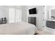 Spacious bedroom with a large bed, modern furniture, and serene ambiance at 10927 White Clay Dr, Las Vegas, NV 89135