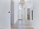 Bright entryway with light wood floors, high ceilings, and modern light fixtures exudes contemporary charm at 10927 White Clay Dr, Las Vegas, NV 89135