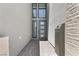 The covered entryway featuring textured walls, modern windows, and an elegant front door at 10927 White Clay Dr, Las Vegas, NV 89135