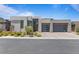 Contemporary home featuring a neutral color palette, modern design, and well-manicured landscaping at 10927 White Clay Dr, Las Vegas, NV 89135