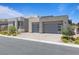 Modern home with a three car garage, well-kept landscaping, and a neutral color scheme on a sunny day at 10927 White Clay Dr, Las Vegas, NV 89135