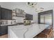 Bright kitchen with a large island, quartz countertops, stainless steel appliances, and modern lighting at 10927 White Clay Dr, Las Vegas, NV 89135