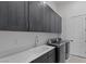 Functional laundry room with washer, dryer, sink, and cabinetry for ample storage at 10927 White Clay Dr, Las Vegas, NV 89135