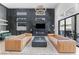 Luxurious living room with modern furnishings, statement lighting, and a sleek fireplace feature at 10927 White Clay Dr, Las Vegas, NV 89135