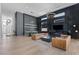 Open-concept living area with modern furnishings, high ceilings, and stylish bar area with shelving at 10927 White Clay Dr, Las Vegas, NV 89135