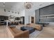 Open-concept living space with kitchen, dining area, and living room featuring high ceilings and modern decor at 10927 White Clay Dr, Las Vegas, NV 89135