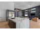 Open-concept living space with kitchen, dining area, and living room featuring high ceilings and modern decor at 10927 White Clay Dr, Las Vegas, NV 89135