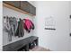 Well-organized mudroom with overhead cabinets, coat hooks, bench seating, and storage cubbies at 10927 White Clay Dr, Las Vegas, NV 89135