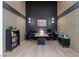 Contemporary home office space with built-in shelving, a large desk, and modern lighting fixtures at 10927 White Clay Dr, Las Vegas, NV 89135