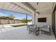 Serene outdoor living space boasts a covered patio, comfortable seating, and manicured landscaping at 10927 White Clay Dr, Las Vegas, NV 89135
