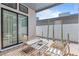 Inviting outdoor patio featuring stylish furniture, wooden deck tiles, and desert landscaping with tall cacti at 10927 White Clay Dr, Las Vegas, NV 89135
