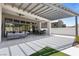 Spacious covered patio featuring comfortable seating, outdoor dining area, and views of the landscaped backyard at 10927 White Clay Dr, Las Vegas, NV 89135