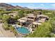 Aerial view of the luxury home, showcasing a beautiful pool, patio, and lush landscaping with mountain views at 11 Golden Sunray Ln, Las Vegas, NV 89135