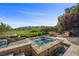 Serene backyard with a relaxing spa, lush landscaping, and a peaceful view at 11 Golden Sunray Ln, Las Vegas, NV 89135