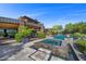 Beautiful backyard featuring a luxurious pool, spa, and fire pit, perfect for relaxation and entertainment at 11 Golden Sunray Ln, Las Vegas, NV 89135