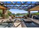 Outdoor area with a covered pergola, fire pit, and water features leading to the pool at 11 Golden Sunray Ln, Las Vegas, NV 89135