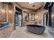 Bathroom featuring dual vanities, a soaking tub, and a frameless glass walk-in shower at 11 Golden Sunray Ln, Las Vegas, NV 89135