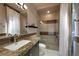 Well-lit bathroom featuring a granite countertop vanity and a glass-enclosed shower at 11 Golden Sunray Ln, Las Vegas, NV 89135