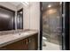 Modern bathroom with stylish vanity, mirror, and walk-in shower at 11 Golden Sunray Ln, Las Vegas, NV 89135