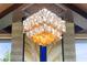 Close-up of elegant chandelier with decorative squares over foyer art in luxury home at 11 Golden Sunray Ln, Las Vegas, NV 89135