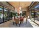 Formal dining room featuring modern lighting, large windows and seating for eight at 11 Golden Sunray Ln, Las Vegas, NV 89135