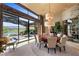 Large formal dining room with outdoor view, custom lighting and seating for ten at 11 Golden Sunray Ln, Las Vegas, NV 89135