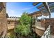 Balcony with stone accents, lush greenery, and architectural wood beam design elements at 11 Golden Sunray Ln, Las Vegas, NV 89135
