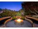 Charming outdoor fire pit area surrounded by built-in seating and lush landscaping at 11 Golden Sunray Ln, Las Vegas, NV 89135