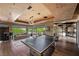 Spacious game room offers table tennis, sofa seating, and access to outdoor views at 11 Golden Sunray Ln, Las Vegas, NV 89135