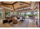 Open living room with wood ceilings, a full bar, and an expansive view to the backyard at 11 Golden Sunray Ln, Las Vegas, NV 89135