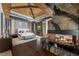 Luxurious main bedroom with a vaulted ceiling, stone fireplace, hardwood floors, and access to outdoor living space at 11 Golden Sunray Ln, Las Vegas, NV 89135