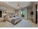 Airy and bright main bedroom with updated lighting, TV and luxury finishes at 11 Golden Sunray Ln, Las Vegas, NV 89135